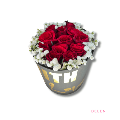 Belen: Twelve red roses surrounded by delicate baby’s breath, beautifully arranged in a stylish dark hatbox, symbolizing deep love.