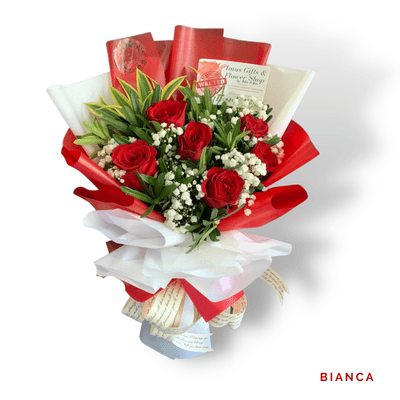 Bianca arrangement on a plain background: Classic red roses with delicate white fillers and greenery, wrapped in elegant red and white accents.