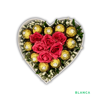 Blanca: Six pink roses form a heart, surrounded by greenery, baby’s breath, and eleven luxurious Ferrero Rocher chocolates.