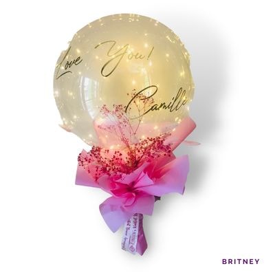 Britney: Magical bubble balloon arrangement with lights and florals, adding charm and sparkle to unforgettable birthday celebrations.
