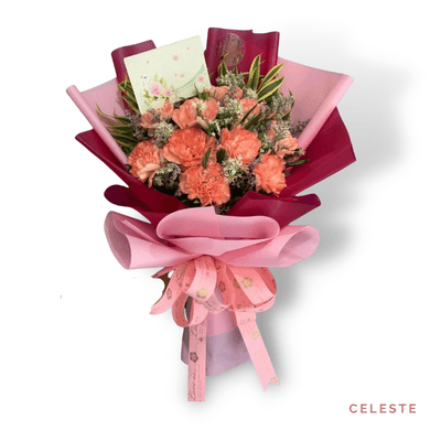 Celeste arrangement on a plain background: Peach carnations with delicate fillers and greenery, wrapped in elegant pink and burgundy paper.