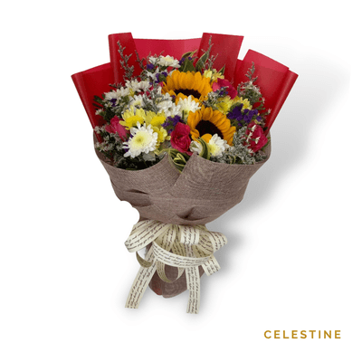 Celestine arrangement on a plain background: A stunning bouquet of cheerful sunflowers, six elegant roses, and lush mums, perfect for celebrations and heartfelt gestures.