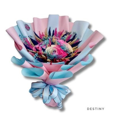 Destiny: Vibrant dried flower bouquet featuring a pastel ranunculus bloom, wrapped in soft pink and blue with a matching ribbon.
