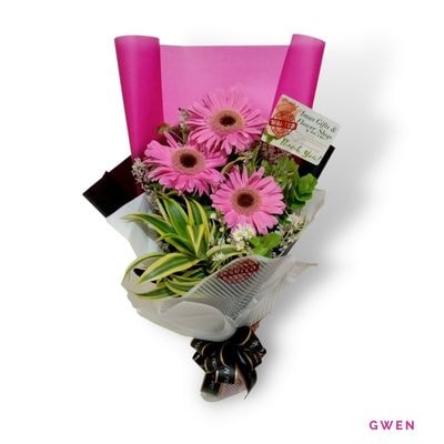 Gwen: Three fresh pink gerberas symbolizing admiration and happiness, beautifully arranged for birthdays, gratitude, and sweet surprises.