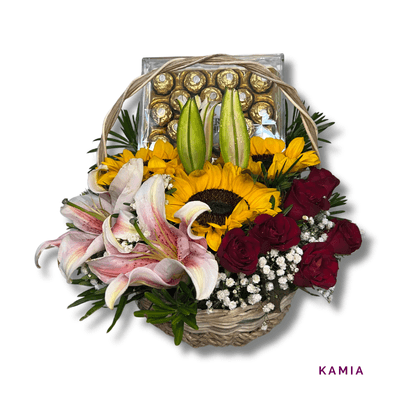 Kamia: Charming basket of sunflowers, red roses, stargazer lily, and Ferrero Rocher chocolates—a beautiful blend of blooms and sweetness.