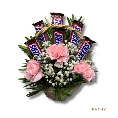 Kathy: Delightful basket of 3 carnations and 6 Snickers bars, blending floral charm with sweet treats.