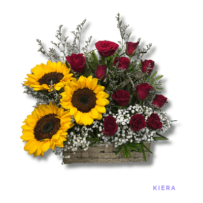 Kiera: Three vibrant sunflowers and twelve red roses beautifully arranged in a rustic basket, symbolizing joy, love, and admiration.