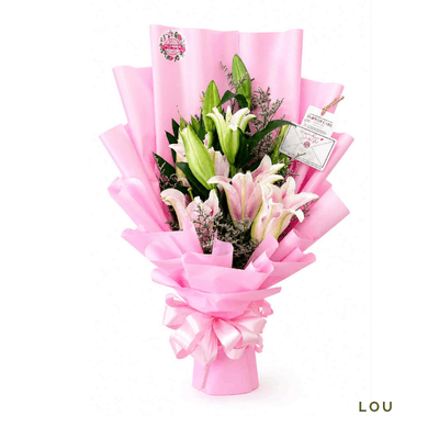 Lucy arrangement on a plain background: Elegant trio of lilies with striking pink petals and a sweet fragrance, perfect for expressing love, admiration, or celebration.