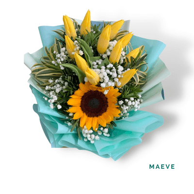 Maeve arrangement on a plain background: A vibrant bouquet of tulips, sunflower, and delicate fillers, perfect for celebrations, birthdays, congratulations, and joyful surprises.