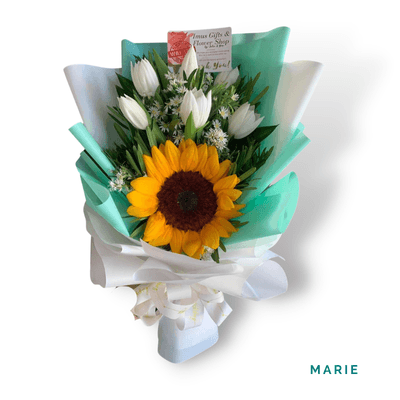 Marie arrangement on a plain background: A radiant sunflower paired with elegant white tulips and fresh foliage, perfect for expressing gratitude, joy, and appreciation.