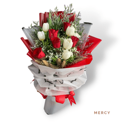 Mercy arrangement on a plain background: Six red roses and six white tulips create an elegant bouquet, perfect for love and heartfelt apologies.