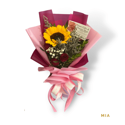 Mia arrangement on a plain background: Cheerful sunflowers paired with three red roses, creating a vibrant bouquet perfect for celebrations, birthdays, and heartfelt surprises.