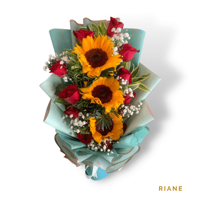 Riane arrangement on a plain background: Three golden sunflowers paired with twelve velvety red roses, creating a bold, elegant bouquet symbolizing happiness and love.