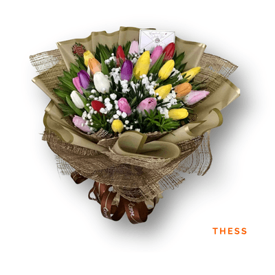 Thess arrangement on a plain background: Twenty-four mixed-color tulips beautifully arranged, bringing springtime charm, beauty, and cheerful elegance to every special occasion.