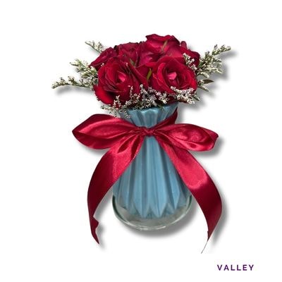 Valley: Three striking fuchsia blooms arranged in an artistic ceramic vase, creating a modern and elegant centerpiece.