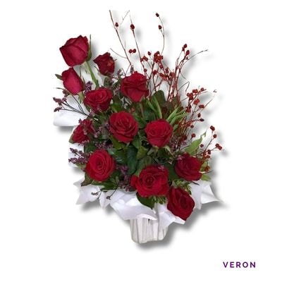 Veron: Twelve long-stemmed red roses beautifully arranged in a ceramic vase, symbolizing timeless love, elegance, and admiration.