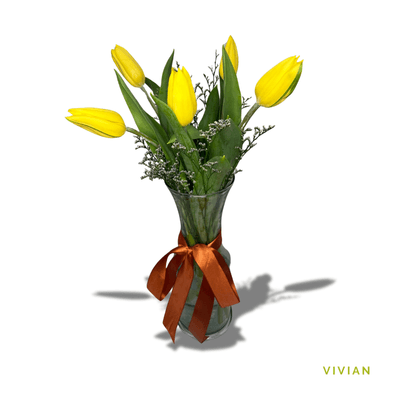 Vivian: Six vibrant yellow tulips beautifully arranged in glass, symbolizing joy, friendship, and new beginnings with graceful elegance.